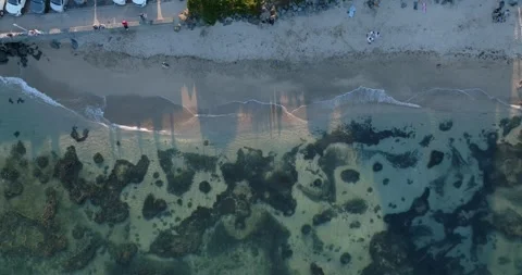 Beach scene with people, waves, and rocks. Takapuna, Auckland, New Zealand Stock Footage 296041400