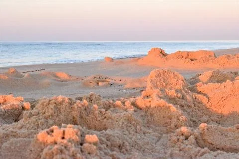 Beach scene with reflections on the sand Stockfoto's