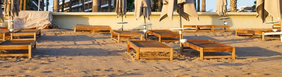 Beach scene in Side Turkey with empty umbrellas and sun loungers. Vacation at Stock Photos