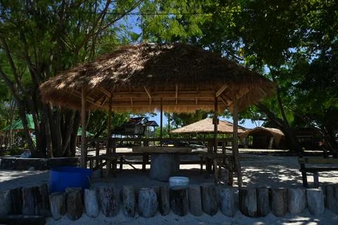 A Beach scene: Small Cottage Between the Trees Stock Photos