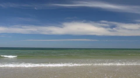 Beach scene with small waves. Peaceful and relaxing. Video stock 65880523