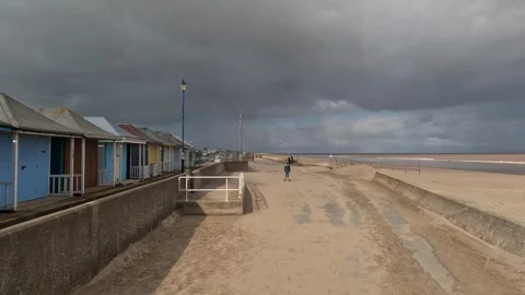 Beach scene on a summers day. Boy riding his hover-board.on the seafront be.. Видео 240285805