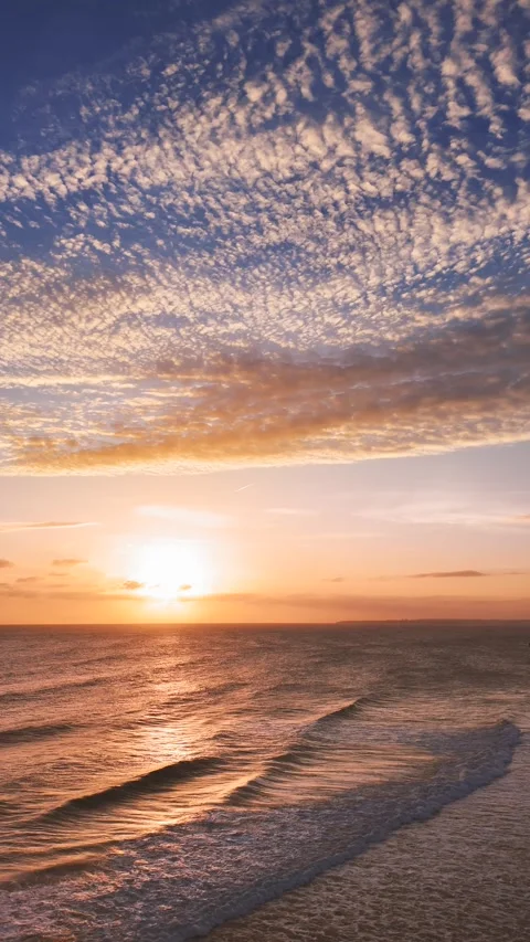 Beach scene at sunset with the coastline stretching into the distance Stock Footage 301013245