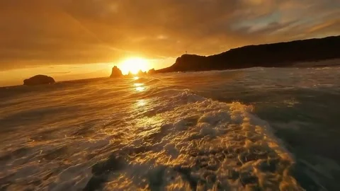 A beach scene at sunset. 스톡 동영상 329304217