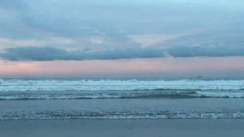 Beach scene at sunset, where powerful waves Stock Footage 330981959