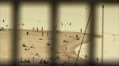 Beach scene through bars Vídeo Stock 12761291