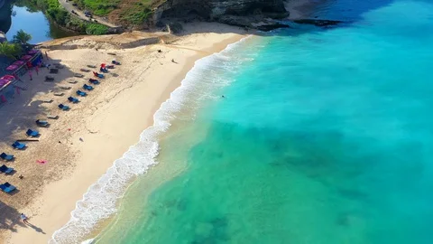 Beach scene - turquoise transparent ocean and white sand beach. Stock Footage 129502460