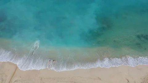Beach scene - turquoise transparent ocean and white sand beach. Stock Footage 129504148