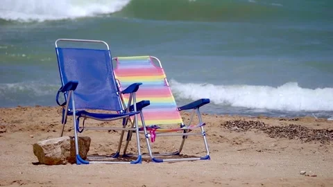 Beach scene with two empty sunbeds with the sea behind. Concept of a romant.. Stock Footage 249172026