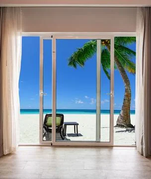 Beach scene with a view of the ocean and a couple of beach chairs Stock Photos