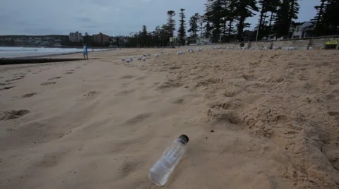 Beach scene with washed up plastic bottle Stock Footage 44974229