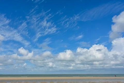 Beach by the sea with clouds on the  sky Stock Photos