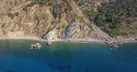 Beach, sea under cliffs and big mountain reveal Stock Footage 93392276