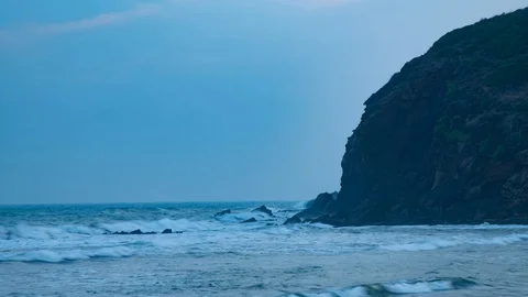 Beach sea waves hitting mountain Stock Footage 98289673