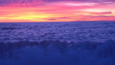 On the beach sea waves at sunset. Stockbeeldmateriaal 122411840