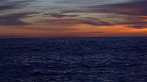 On the beach sea waves at sunset. Stockbeeldmateriaal 122412218