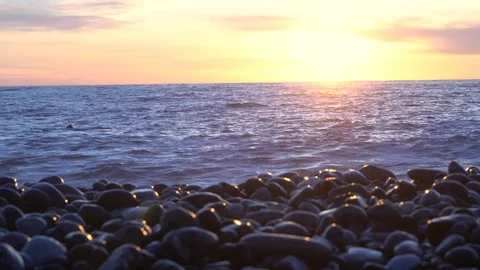 On the beach sea waves at sunset. Stockbeeldmateriaal 122440440