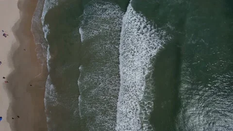 Beach seen from above, several waves arriving on the sand, calm beach Stock Footage 229851803
