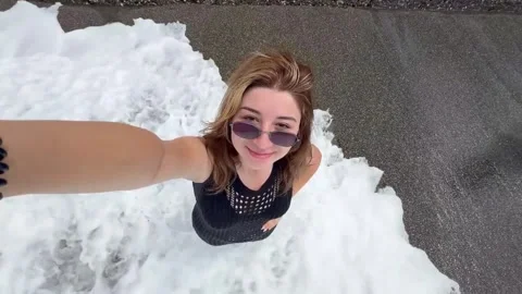 Beach selfie turns chaotic as wave crashes ashore in Sochi, Russia Stock Footage 341374967