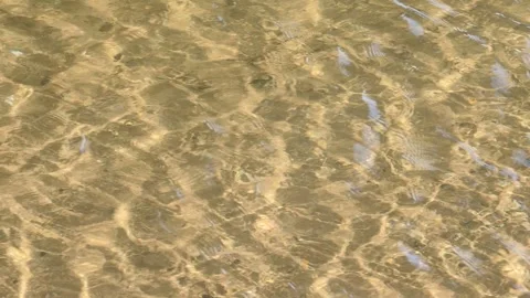 Beach shallow clear water waves texture with river shore yellow sand video Stock Footage 296140327
