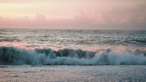 Beach shore with pebbles, sand on the sunset with waves crushing Stock Footage 180949662