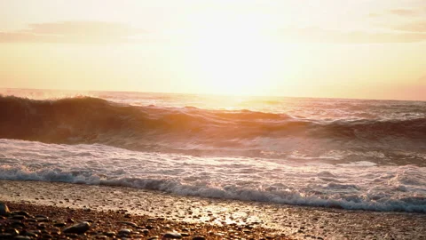 Beach shore with pebbles, sand on the sunset with heavy waves crushing Stock Footage 180952618