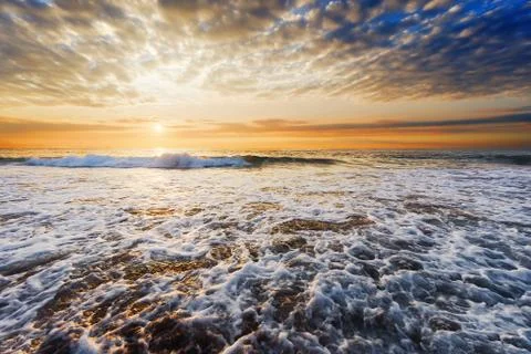 Beach shore at sunset Stock Photos