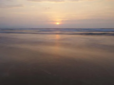 Beach shore at sunset Stock Photos