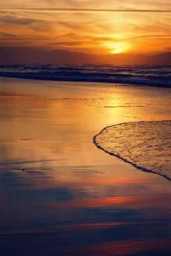 Beach shore at sunset Stock Photos