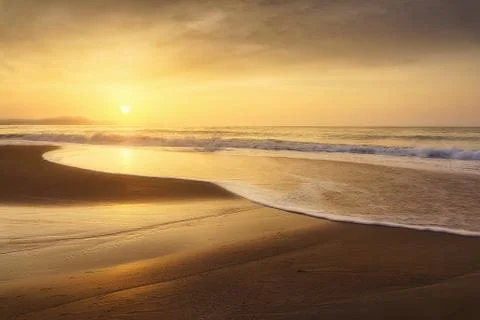 Beach shore at sunset Stock Photos