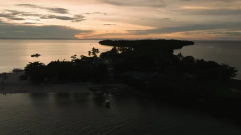 Beach shoreline with sunset sky and anchored boats. Camotes, Philippines. Stock Footage 342511346