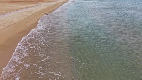Beach shoreline with waves and clear water on sunny day Video stock 335143327