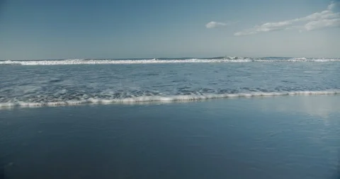 Beach Shoreline Waves Rolling In Towards Camera 動画素材 128451753