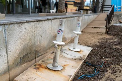 Beach shower stations closed on empty seaside promenade 库存照片
