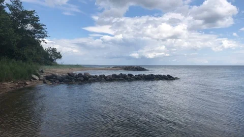 Beach From The Side 4K Coast Clouds Rocks Water Sand Stock Footage 114770408