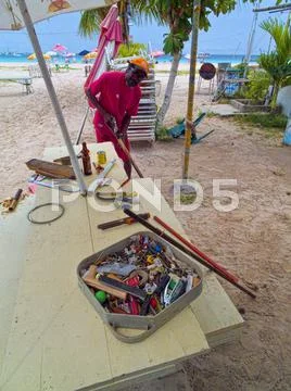 Beach Side Carpenter Repairing Umbrellas