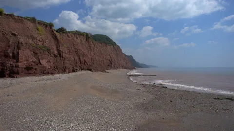 The beach at Sidmouth in Devon.  Pebbles and sand.  Deserted in early summer Video stock 156187930