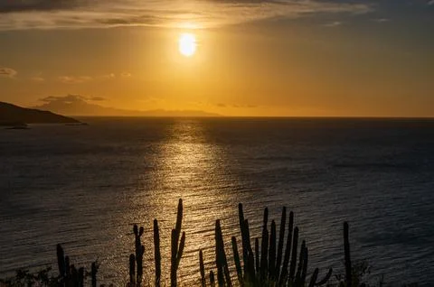 A beach with a small hill in the background Foto stock