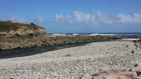 A beach of small stones close to the river in Fazouro, Spain Stock Footage 234023702