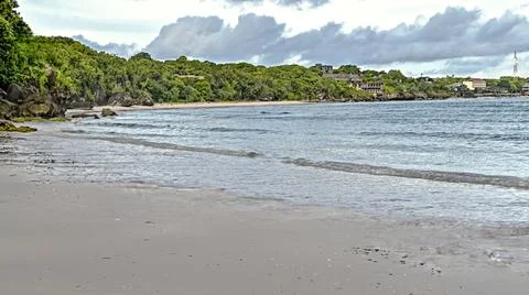 A beach with a small town in the background Stock Photos