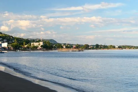 A beach with a small town in the background Stock Photos