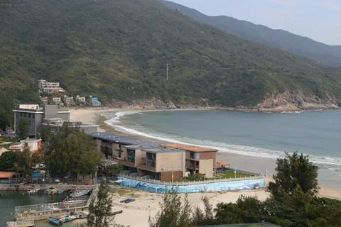 A beach with a small town in the background Stock Photos