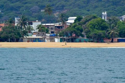 A beach with a small town in the background Stock Photos