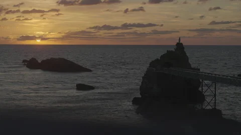 Beach with statue rock at sunset Video stock 346282076
