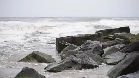 Beach storm surf over jetty Stock Footage 75770045