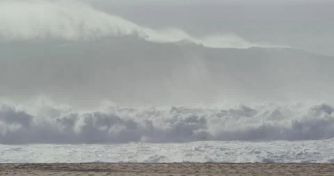 Beach with stormy ocean waves breaking and moving in slow motion in Nazare Stock Footage 149939286