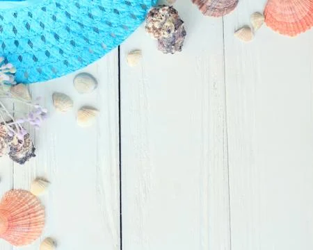 Beach straw hat and seashells on a wooden background.photo with place for text Stock Photos