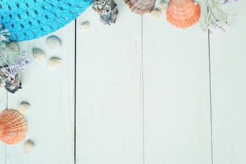 Beach straw hat and seashells on a wooden background.photo with place for text Stock Photos