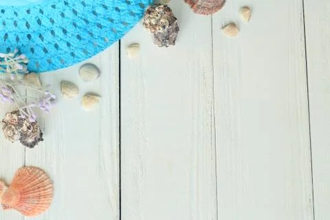 Beach straw hat and seashells on a wooden background.photo with place for text Stock Photos