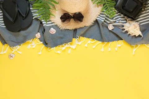 Beach straw sun hat, seashells on yellow background. Summer Stock Photos